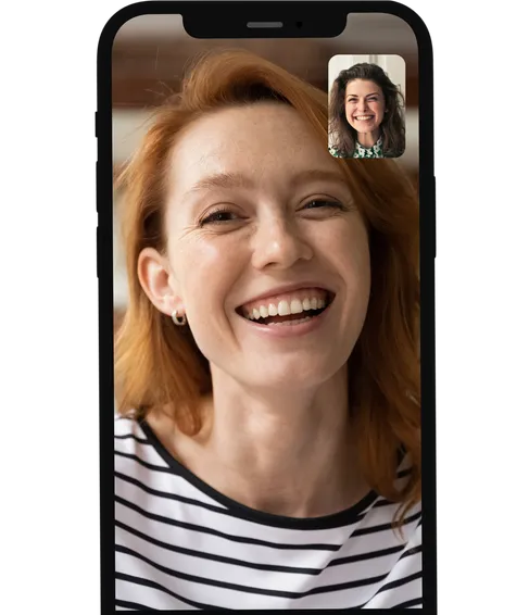 Smiling ginger woman having a video call on her phone with her therapist