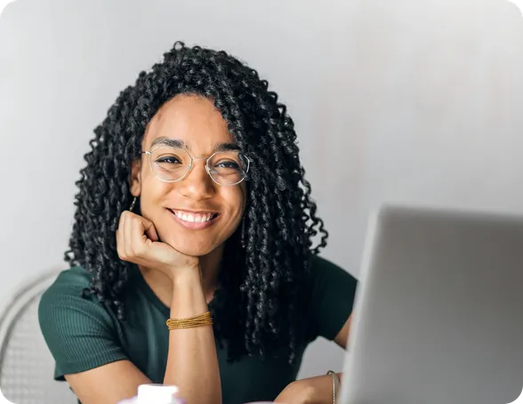 Smiling curly-haired woman having a video call with her patient